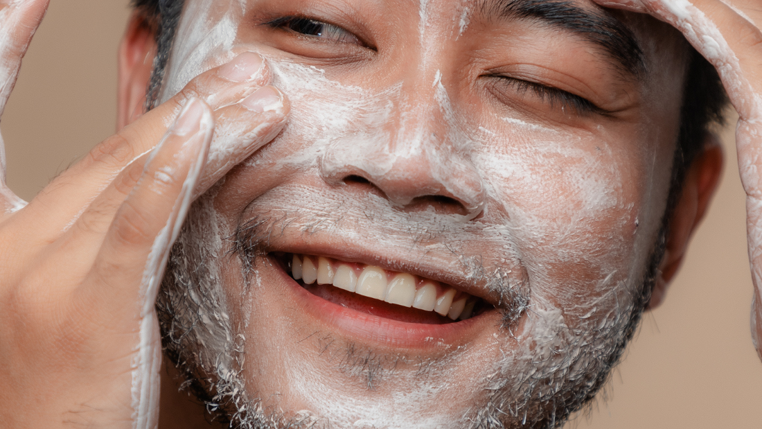 A man washes his face with soap
