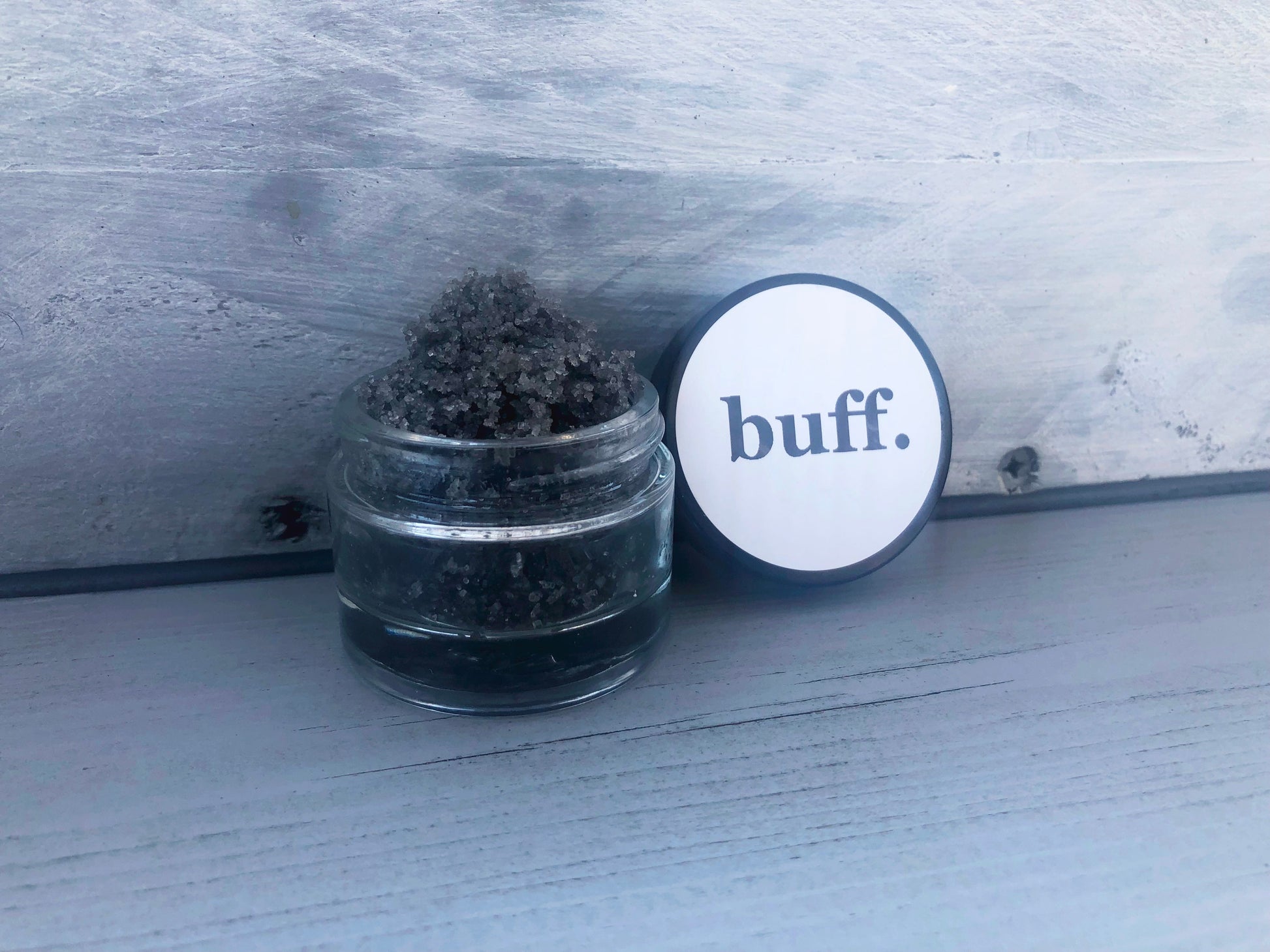 Salted Caramel grey black sugar lip scrub used for exfoliating in a glass jar