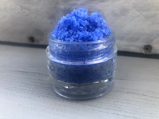 Blue bubblegum sugar lip scrub used for exfoliating in a glass jar